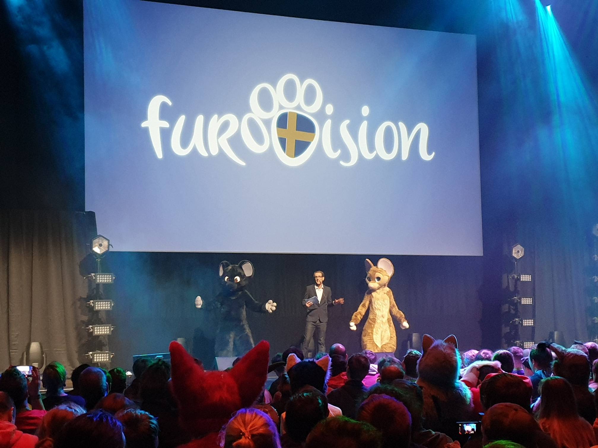Dalziel presenting the Eurovision parody stage show with two animal character mascots